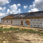 Tennessee barndominium under construction with exposed roof framing and exterior wall structure